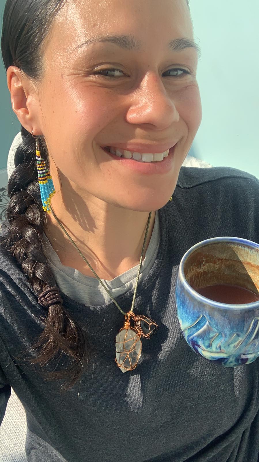 Lou Boifuana, holding a cup of cacao